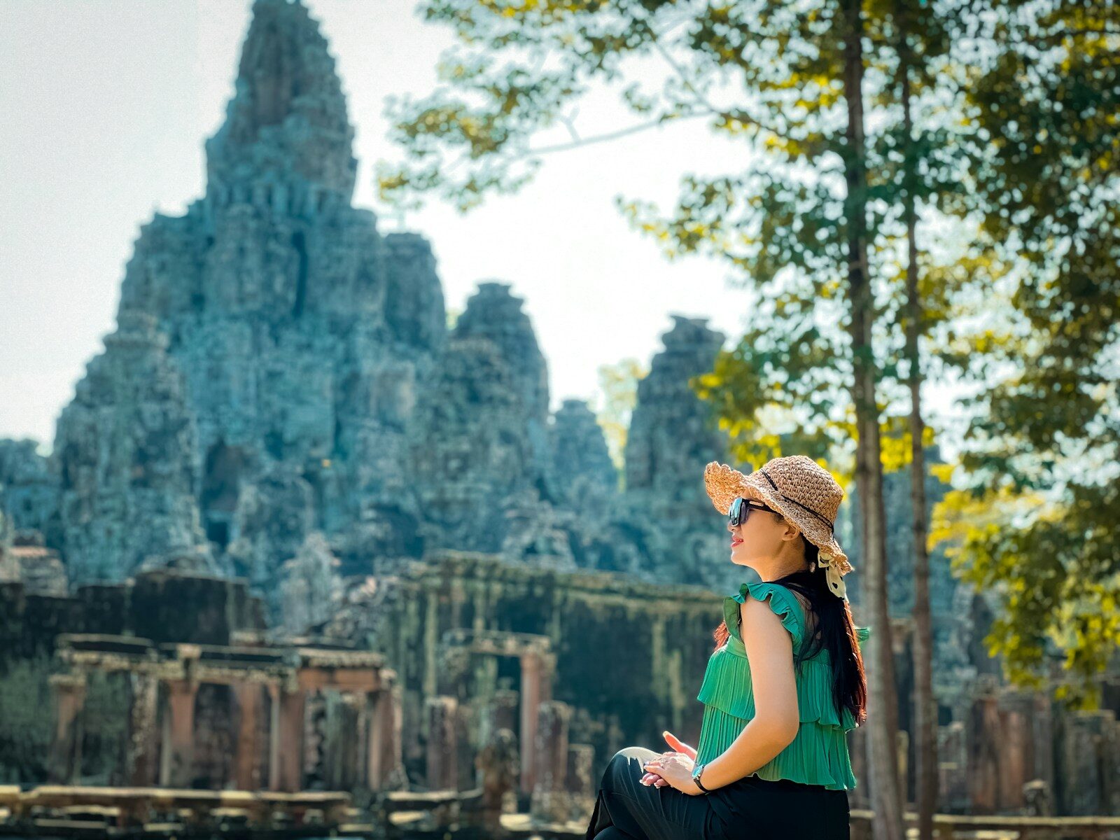a woman sitting on a bench in front of a building